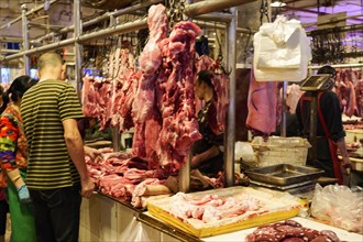 Chongqing, Chongqing Province, China, View of a busy meat market with customers and hanging pieces