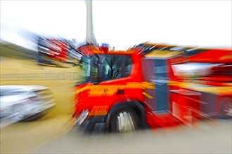 Fire engine in motion with strong blur, suggesting dynamics