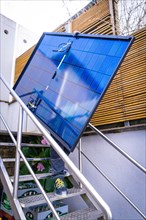 A technician installs a solar panel on a staircase, Solar Anlagen Bau, Handwerk, Muehlacker,