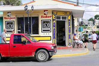 San Juan del Sur, Nicaragua, Bakery and cafe on a busy street corner with people walking by,
