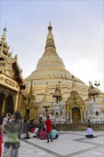 Shwedagon Pagoda, Yangon, Myanmar, Asia, Visitors in front of the golden Shwedagon Pagoda with