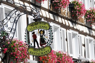 Eguisheim, Alsace, France, Europe, Hotel and restaurant sign 'Auberge Alsacienne' with floral