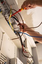An electrician works carefully on a fuse box, Solar systems construction, Craft, Muehlacker,