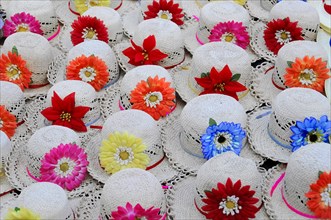 Leon, Nicaragua, Colourful decorated hats with flowers on a traditional market stall, Central