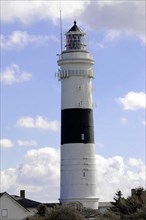 Langer Christian lighthouse on the island of Sylt, Imposing black and white lighthouse towers into