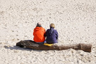 On the beach, Hoernum, Sylt, North Frisian Island, Schleswig Holstein, Two people sit on a