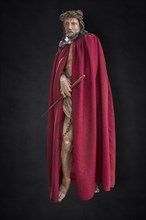 Life-size, carved figure of Jesus with a red cloak on a dark background, 350-year-old processional