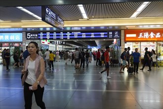 Hongqiao Railway Station, Shanghai, China, Asia, People walking past various shops in a busy