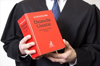 Lawyer in robe with German law book, 15.01.2015., Berlin, Berlin, Germany, Europe