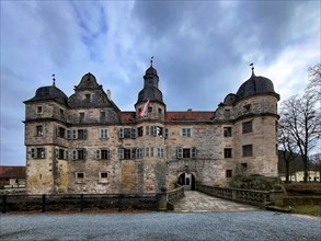 Mitwitz moated castle under a cloudy sky. Mitwitz, Kronach, Upper Franconia, Bavaria, Germany,