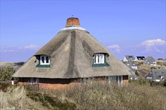 Hoernum, Sylt, North Frisian Island, close-up of a house with thatched roof under a clear blue sky,