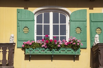 Old, green wooden window with shutters and flower box, Garmisch district, Garmisch-Partenkirchen,