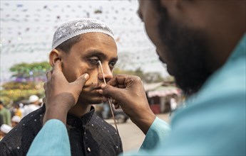 GUWAHATI, INDIA, APRIL 11: A Muslim man applies Surma on eyes during Eid Al-Fitr in Guwahati, India