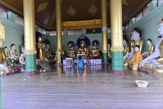 Shwedagon Pagoda, Yangon, Myanmar, Asia, Interior of a temple with Buddha statues and worshippers,