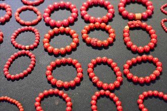 Chongqing, Chongqing Province, China, Asia, Collection of red handmade bracelets on a dark