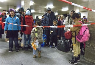 Refugees have arrived at Schoenefeld station on an IC train. They are then taken by bus to