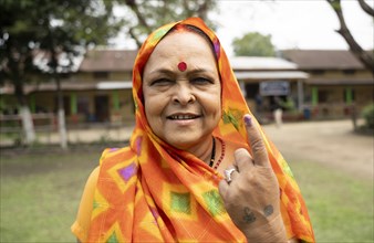 BOKAKHAT, INDIA, APRIL 19: A women show her marked finger after casting vote during the first phase