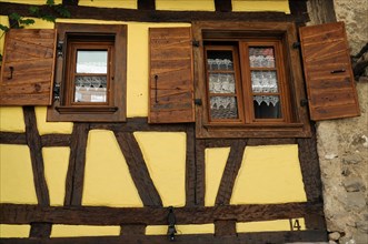 Eguisheim, Alsace, France, Europe, Traditional half-timbered house with wooden shutters and lace