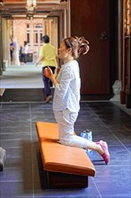 Jade Buddha Temple, Shanghai, A woman prays reverently in a quiet temple interior, Shanghai, China,