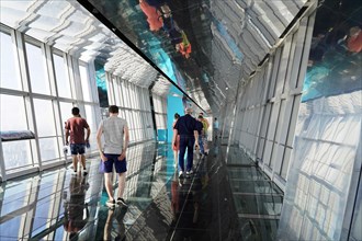 Observation deck, The Bottle Opener at 492 metres, people walking on a glass floor of an