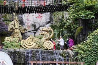 Chongqing, Chongqing Province, China, Asia, Sculpture of a dragon at an artificial waterfall,