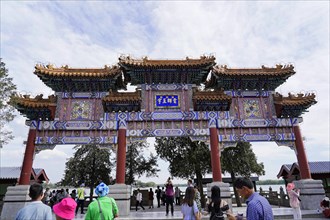 New Summer Palace, Beijing, China, Asia, People walk through a magnificent gate of traditional