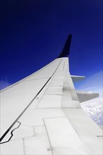 View upwards to an aeroplane wing with clear blue sky in the background, AUGUSTO C. SANDINO