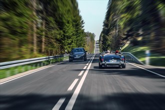 Zoom effect, country road near Boerwang with old MG sports car, Allgaeu, Swabia, Bavaria, Germany,