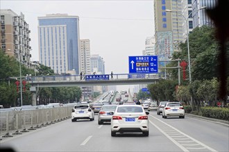 Xian, Shaanxi, China, Asia, city motorway with moving cars and road signs, surrounded by buildings,