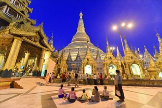 Shwedagon Pagoda, Yangon, Myanmar, Asia, Group of people in the evening in front of the impressive