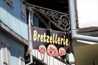 Eguisheim, Alsace, France, Europe, A sign with a pretzel motif representing a speciality of the