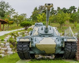 Front view of military tank with camouflage paint on display in public park in Nonsan, South Korea,