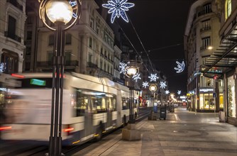 Main Shopping Street with a Bus at Night in geneva, Switzerland, Europe