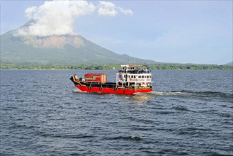 Lake Nicaragua, in the background the island of Ometepe, Colourful ferry on the lake, transporting