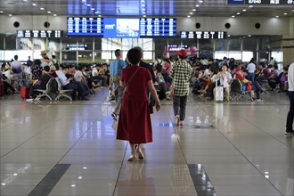 Hongqiao Railway Station, Shanghai, China, Asia, A person in red clothing walks through an airport