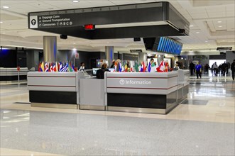 AUGUSTO C. SANDINO Airport, Managua, Nicaragua, Information stand with flags and employees at an