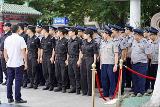 Chongqing, Chongqing Province, China, Asia, Police officers in uniform stand in a formation and