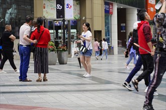 Chongqing, Chongqing Province, China, Asia, People interacting with each other in front of a
