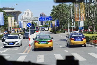 Beijing, China, Asia, city scene with several cars on the street and clear blue sky in the