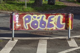 Colourfully smeared traffic sign with the inscription Poebel, Germany, Europe