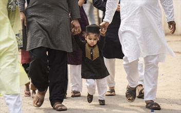 GUWAHATI, INDIA, APRIL 11: Muslim people with children walk towards an Eidgah to perform Eid