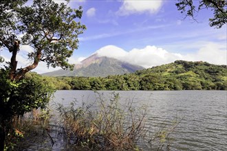 Ometepe Island, Nicaragua, Impressive volcano view over a lake surrounded by green vegetation,