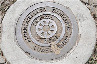 Leon, Nicaragua, A manhole cover with an inscription on a concrete pavement, Central America,
