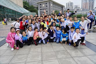 Chongqing, Chongqing Province, China, Asia, Joyful children pose together in an urban environment,