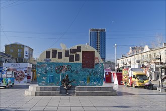 Beatles monument with graffiti and slogans on Tserendorjiin Gudamj Street in front of street food