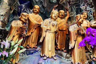Jade Buddha Temple, Shanghai, Colourful relief of sculptures in traditional robes with purple