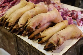 Chongqing, Chongqing Province, China, Pigs' feet neatly draped on a market stall, Chongqing,