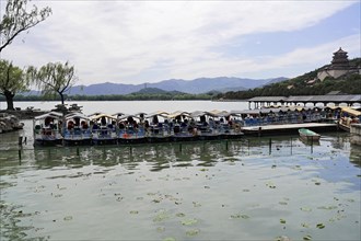 New Summer Palace, Beijing, China, Asia, Tourist boats on a lake with green water in front of a