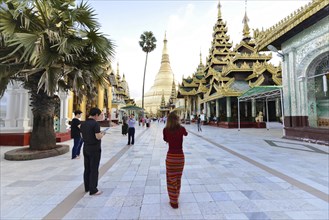 Shwedagon Pagoda, Yangon, Myanmar, Asia, people visiting a large pagoda, some taking photos, Asia