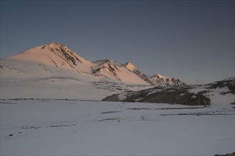 Sunrise at the snowy Cold Peak, 3373m, Tavan Bogd National Park, Mongolian Altai Mountains, Western